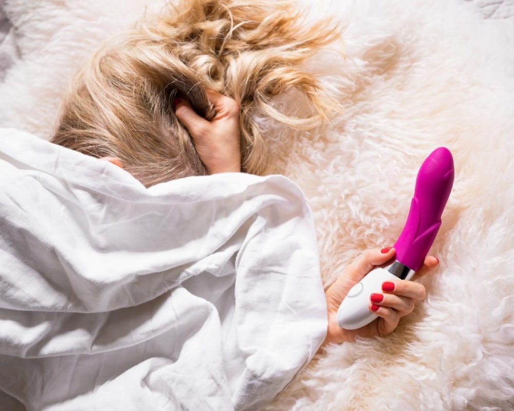 girl with a vibrator in her hands is nervous