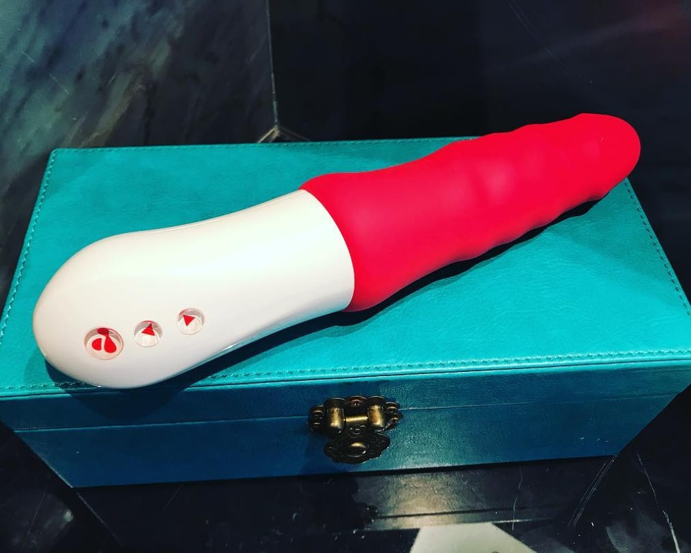 pink dildo on a blue box