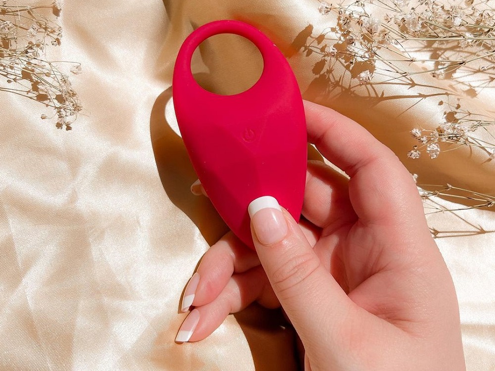 woman holding small red vibrator