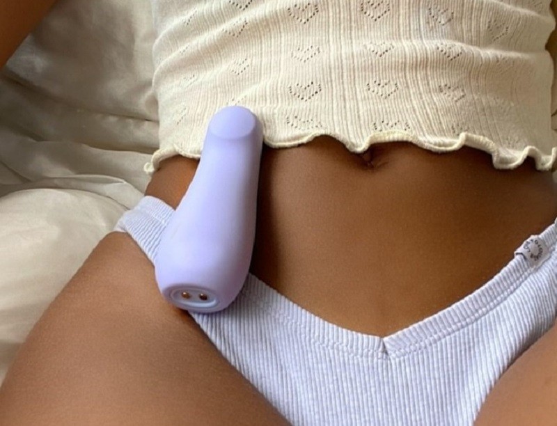 woman with little blue vibrator